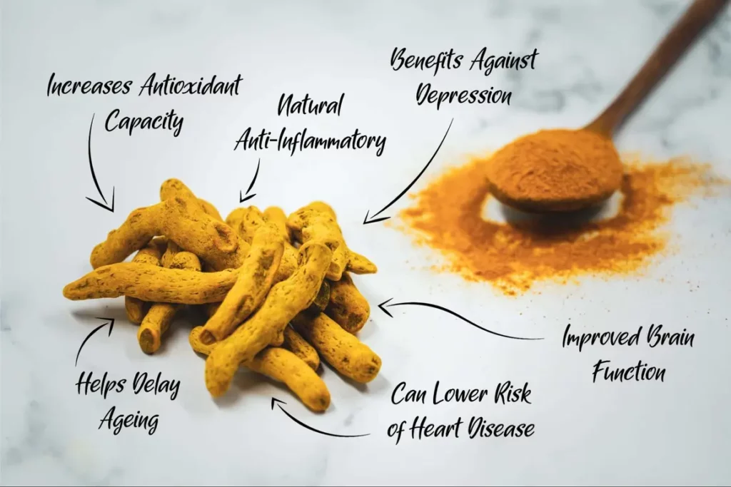 A wooden spoon sitting next to a pile of turmeric.